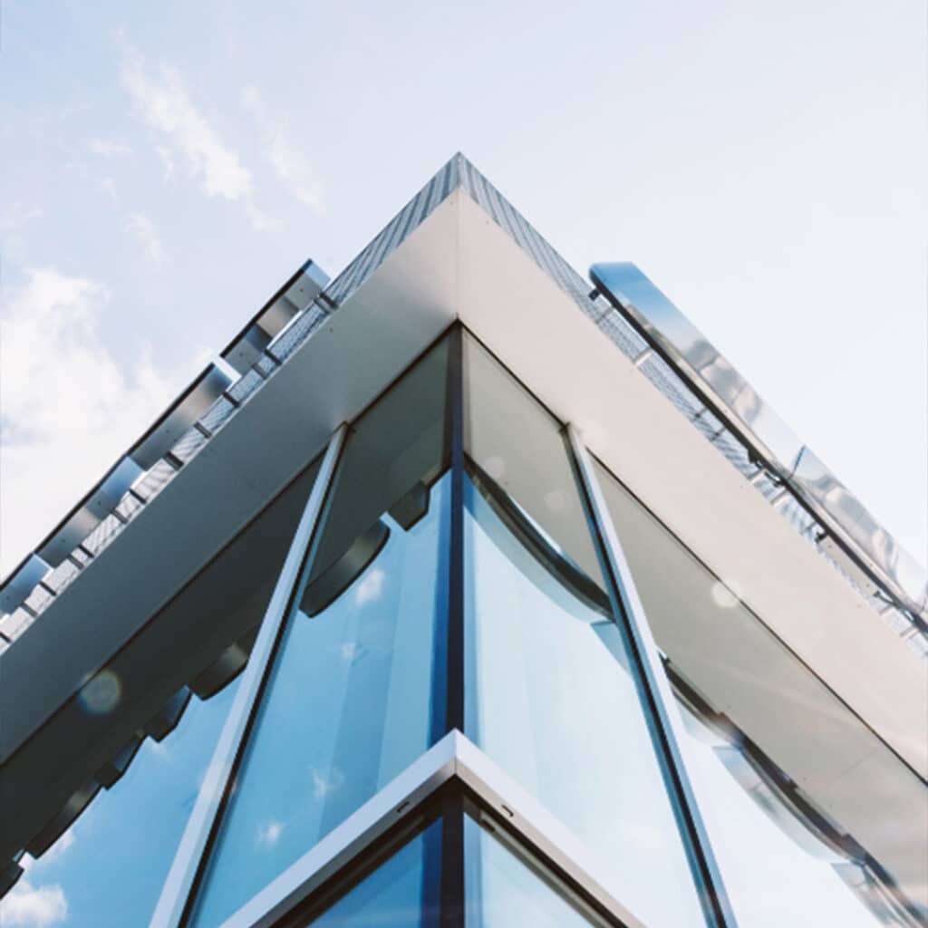 Modern corporate office building with glass exterior for business and financial services.